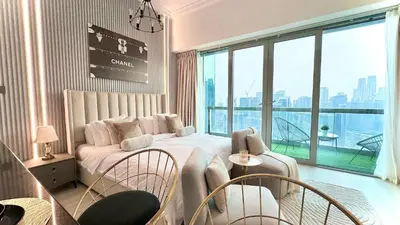 a bedroom with a bed and a large window at Luxury Family Studio Close to Dubai Mall and Burj Khalifa in Dubai