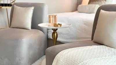 a bedroom with two beds and a table and two chairs at Luxury Family Studio Close to Dubai Mall and Burj Khalifa in Dubai