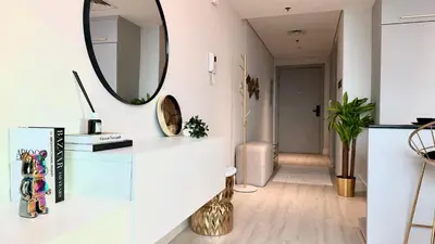 a living room with a mirror and a hallway at Luxury Family Studio Close to Dubai Mall and Burj Khalifa in Dubai