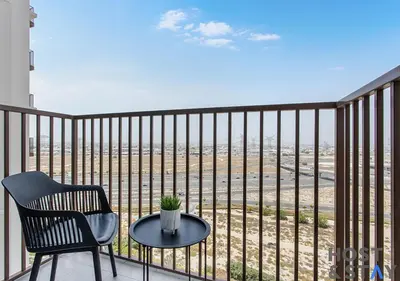 a chair and a table on a balcony with a view at Serene 1BR Getaway In Collective in Dubai