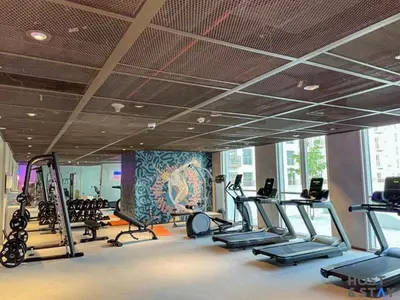 a gym with treadmills and elliptical machines at Serene 1BR Getaway In Collective in Dubai