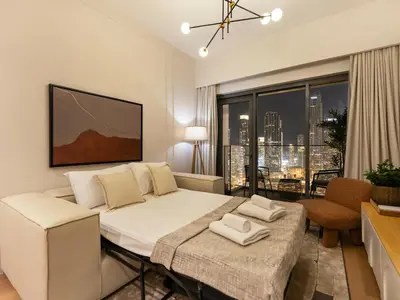 a bedroom with a bed and a living room at The Burj Khalifa Suite Luxury 2-bed in Burj Royale in Dubai