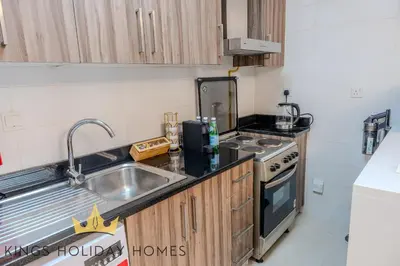a small kitchen with a sink and a stove at Dunya tower 2 downtown burj khalifa street Kings in Dubai