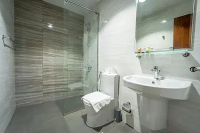 a bathroom with a toilet and a sink and a shower at AWS Holiday Homes - In the Heart of Downtown in Dubai