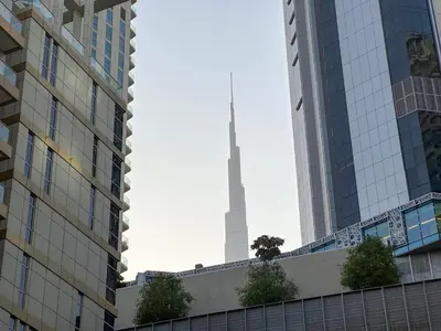 a view of the seoul tower from between buildings at AWS Holiday Homes - In the Heart of Downtown in Dubai