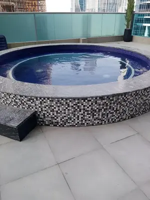 a large circular pool in a building at Elite Residence - Business Bay in Dubai