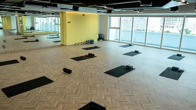 a large room with a lot of yoga mats at Medore Brand New 1 and a half Bedroom apartment in Dubai