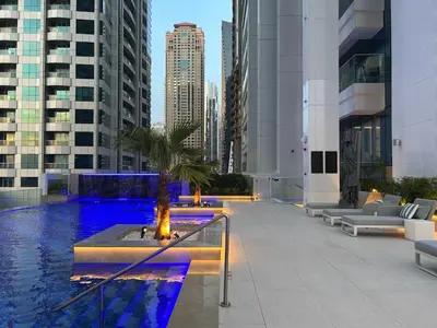 a pool in the middle of a city with buildings at Medore Brand New 1 and a half Bedroom apartment in Dubai