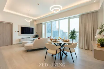 a living room with a table and chairs and a couch at Me Do Re - Luxury Living 1 BR with Panoramic View - Zed Living in Dubai