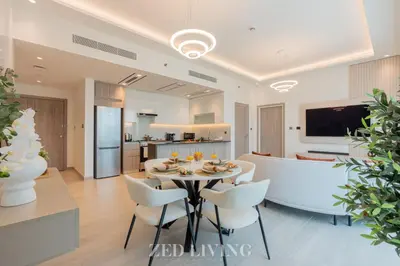 a dining room and living room with a table and chairs at Me Do Re - Luxury Living 1 BR with Panoramic View - Zed Living in Dubai