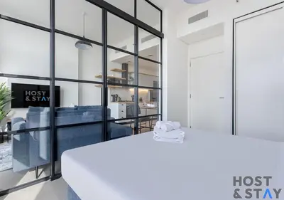 an office with glass walls and a white table at Stunning 1bed In Dubai Hills in Dubai