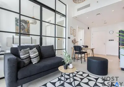 a living room with a couch and a table at Amazing 1BR in Collective2, Dubai Hills in Dubai