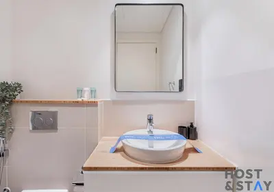 a bathroom with a bowl sink and a mirror at Serene 1BR Getaway In Collective in Dubai