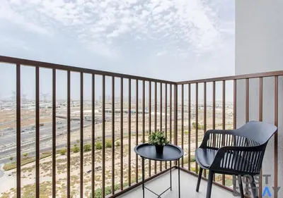 a chair and a table on a balcony with a view at Serene 1BR Getaway In Collective in Dubai