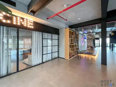 a lobby with a room with a bed and glass doors at Serene 1BR Getaway In Collective in Dubai