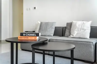a living room with two tables and a couch at ShoresInn - Spacious unit with Dubai Marina View in Dubai