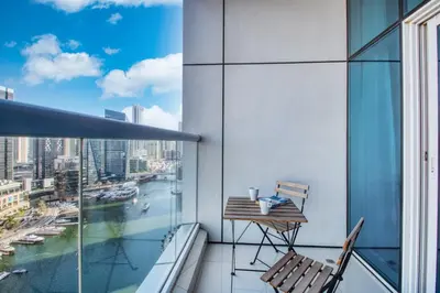 a balcony with a table and chairs on a building at ShoresInn - Spacious unit with Dubai Marina View in Dubai
