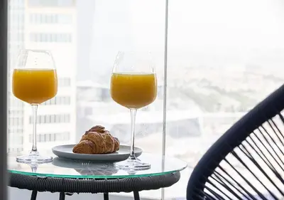 two glasses of orange juice and a pastry on a table at Luxury home with stunning view in Dubai