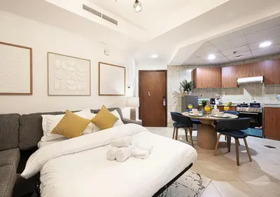 a living room with a bed and a dining room at Luxury home with stunning view in Dubai