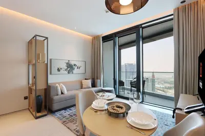 a living room with a couch and a table in a room at 1BHK with Marina and Partial Sea Views in Dubai