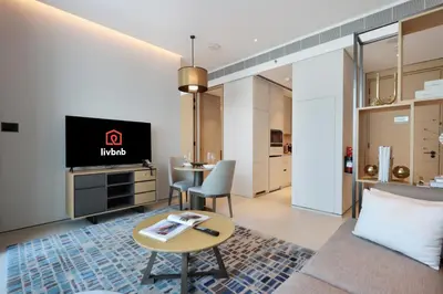 a living room with a tv and a table at 1BHK with Marina and Partial Sea Views in Dubai