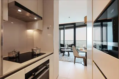 a kitchen and dining room with a view of the city at 1BHK with Marina and Partial Sea Views in Dubai