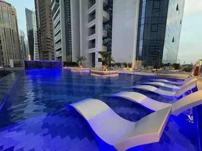 a swimming pool in a city with tall buildings at Medore Brand New Flat in Dubai - 8 in Dubai