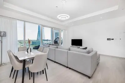 a living room with a couch and a table with chairs at Medore Entire Brand New Flat in Dubai in Dubai