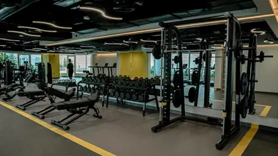 a gym with a bunch of equipment in a room at Medore Entire Brand New Flat in Dubai in Dubai