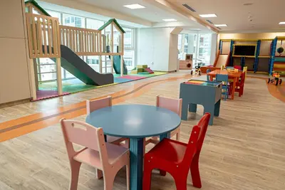 a classroom with tables and chairs and a playground at Medore High Floor Brand New Apartment - 27 in Dubai