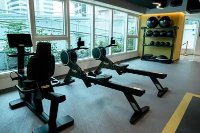a gym with treadmills and exercise bikes in a room at Medore High Floor Brand New Apartment - 27 in Dubai