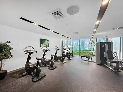 a gym with treadmills and elliptical machines at Burj View Infinity Pool - Dubai Mall Connection in Dubai
