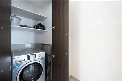 a washer and dryer in a small room at Burj View Infinity Pool - Dubai Mall Connection in Dubai