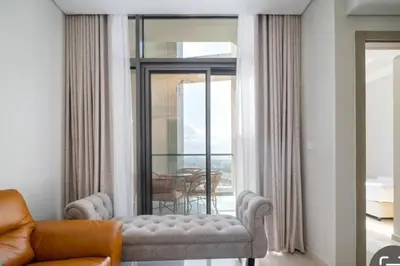 a living room with a couch and a window at Aykon City 2 bedroom Burj view in Dubai