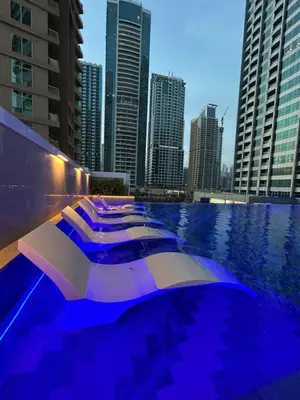 a row of boats in a pool in a city at High Floor Brand New Apartment - 34 in Dubai