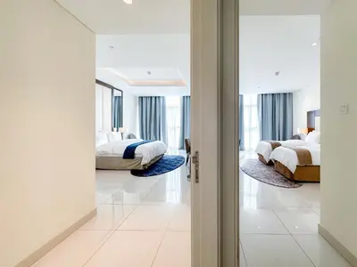 a bedroom with two beds and a mirror at Panoramic Burj Khalifa View Luxury 2BR Penthouse in Dubai