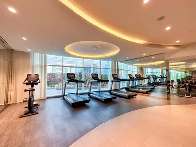 a gym with a row of treadmills in a building at Panoramic Burj Khalifa View Luxury 2BR Penthouse in Dubai