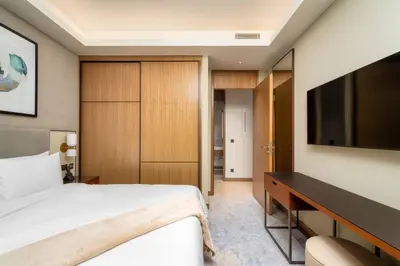 a bedroom with a bed and a desk and a television at Address Emaar Flagship Burj Khalifa Fountain view UPSCALE in Dubai