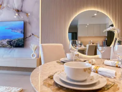 a table with plates and glasses on it in a room at Luxury - Fountain Show & Burj Khalifa View - 2 BR - 3 beds in Dubai