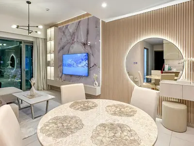 a dining room with a table and a tv on a wall at Luxury - Fountain Show & Burj Khalifa View - 2 BR - 3 beds in Dubai