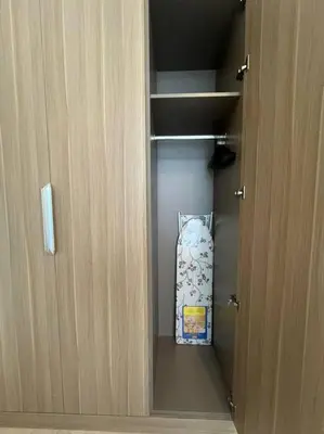 a door to a cupboard with a pillow in it at Lovely Studio, Azizi Riviera in Dubai