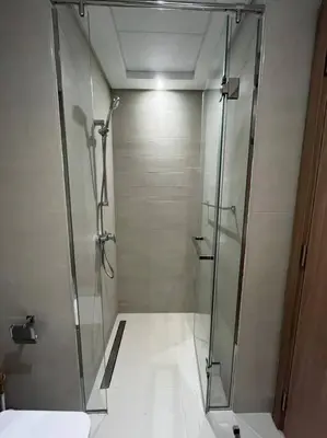 a shower with a glass door in a bathroom at Lovely Studio, Azizi Riviera in Dubai