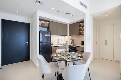 a kitchen and dining room with a table and chairs at Luxury Minimalistic Apartment in Downtown Dubai Opposite Burj Khalifa & Dubai Mall in Dubai