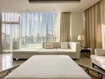a living room with two white couches and a large window at Panoramic Burj Khalifa View Luxury 1BR Penthouse in Dubai