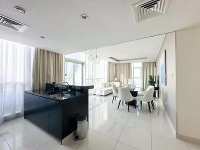 a kitchen and dining room with a table and chairs at Panoramic Burj Khalifa View Luxury 1BR Penthouse in Dubai
