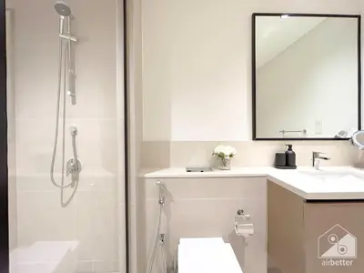 a bathroom with a shower and a sink and a mirror at Luxury Burj Crown Downtown Balcony & View in Dubai
