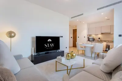 a living room with a couch and a tv at STAY BY LATINEM Luxury 2BR Holiday Home CVR B1705 near Burj Khalifa in Dubai