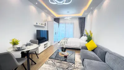 a living room with a couch and a table at Dubai Marina - Modern Classic Studio Apartment in Dubai