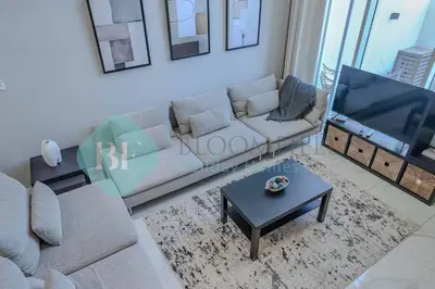 a living room with a couch and a flat screen tv at Bloomfields Cozy 1br Townhouse Life Style City in Nadd Shubayḩ
