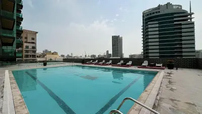 a large swimming pool on the roof of a building at LUXE | Studio in JVC | Cozy and Stylish in Dubai